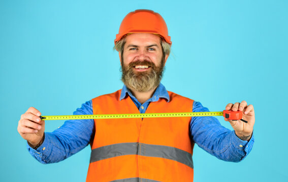 Safety Engineer Measure Acceptable Parameters. Builder with tape measure. Custom made furniture. Worker use tape measure. Size concept. Hipster in hard hat. Make measurements apartment renovation