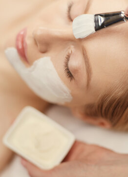 Spa facial mask application. Spa beauty organic facial mask application at day spa salon.