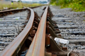 Train tracks and rusty rails. Rarely used old train tracks leading to old deserted docklands in...