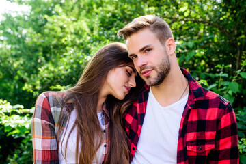 Fototapeta premium Passionate love. family weekend. romantic date. hipster couple outdoor. man and woman in checkered shirt relax in park. couple in love. Hiking. valentines day. summer camping in forest