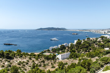 Fototapeta na wymiar Beautiful view of the sea and tourist relaxing on the beaches of Ibiza in Spain