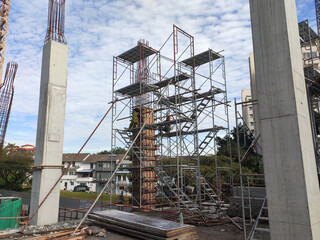 SEREMBAN, MALAYSIA -MAY 24, 2020: Temporary access and metal staircase made from staging, scaffolding and metal platform under construction at the construction site. 