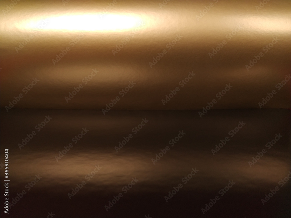 Poster gradient on a brown background. horizontally folded shiny paper or foil with overflow and glare. sof