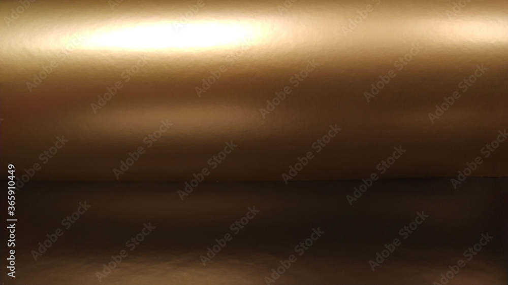 Poster gradient on a brown background. horizontally folded shiny paper or foil with overflow and glare. sof