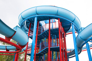 Colourful plastic slides in aquapark in the sunset. sliders, water park at Balaton Lake, Hungary, Europe