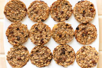 Top view oatmeal cookies on a white plate.