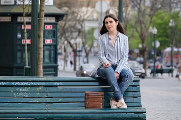 young woman sitting on a bench