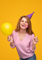 Cheerful young woman with party accessories
