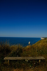 A bench in front of the ocean
