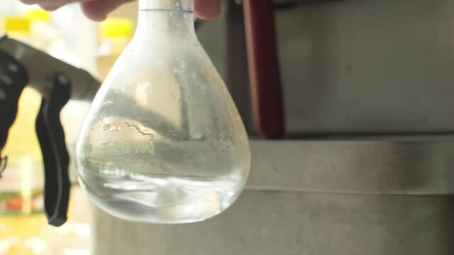 chemist putting liquid in a machine for analysis slow motion