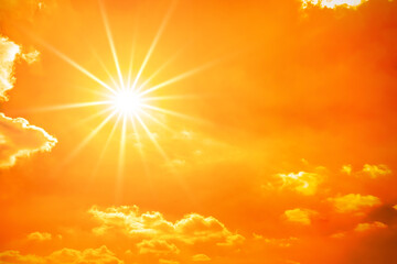 Hot summer or heat wave background, orange sky with clouds and glowing sun - 365915236