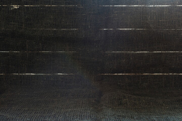 Background image of boards with slits and burlap