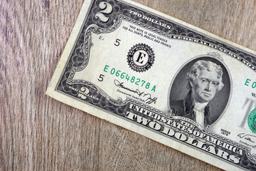 two dollar bill made in 1976 on a wooden table. copy space