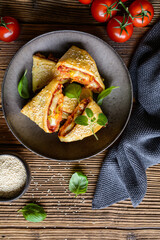 Puff pastry pizza triangle rolls stuffed with tomato sauce, ham, cheese, corn, olives and sprinkled with sesame seeds