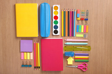 Bright stationery and glasses on a wooden background. Flat lay