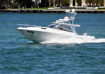 White sport fishing boat with tuna tower on the Florida Intra-Coastal off of Miami Beach.