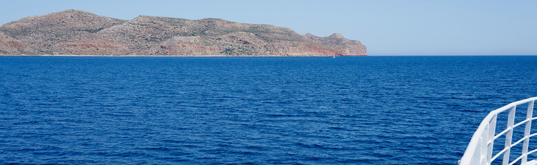 Fototapeta na wymiar Rocky coast line of Crete, Greece. View from the ship. Copy space.