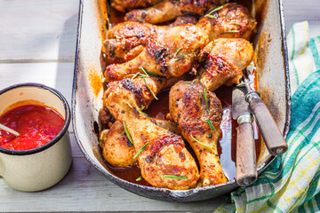 Tasty chicken legs with herbs and spicy sauce