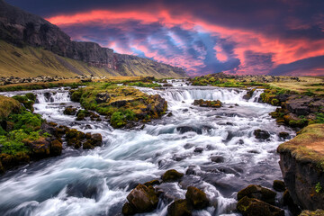 Scenic image of Iceland nature. Amazing Natural scenery. Colorful summer sunrise, Waterfall with dramatic picturesque sky. Picture of wild area. Iceland the most beautiful and best travel place