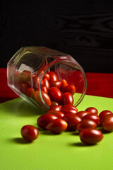 Cherry tomatoes in a glass jar on the table