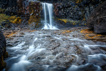 Typical Icelandic scenery. Fresh green hills and waterfall. Picture of wild area. Iceland. Amazing nature landscape. long exposure image. Picture of wild area. Most beautyful locations in world