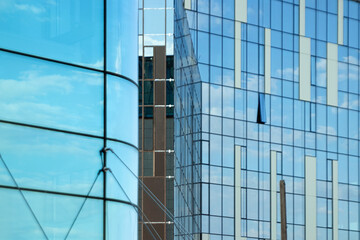 Glass office building, view of the sky reflected in the windows. Concept for work, business, offices. Copy space.