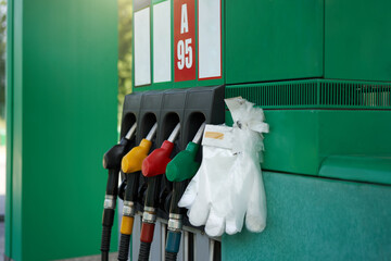 Coronavirus, covid-19 pandemic protective glove gas station gun. Epidemy protection. Personal protective equipment.