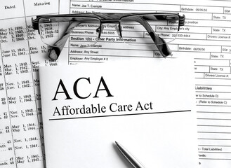 Paper with text ACA Affardable Care Act on a table