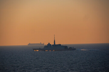 high speed Navy ship, sunset
