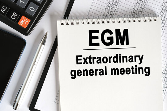 On the table lies a smartphone, a calculator and a notebook with the inscription- EGM.