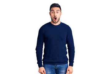 Fototapeta premium Young handsome man wearing casual clothes afraid and shocked with surprise expression, fear and excited face.