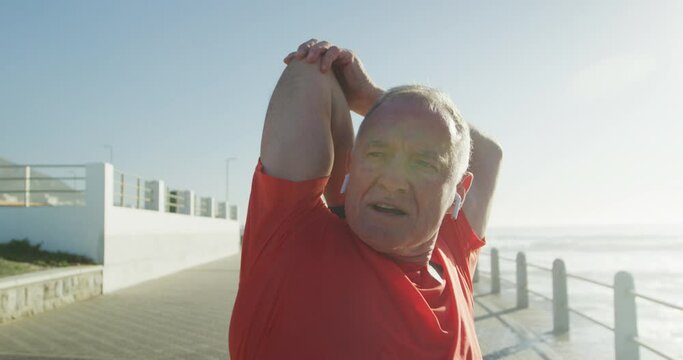 Senior man stretching his arms on the promenade