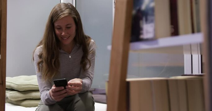 Creative businesswoman using smartphone in modern office