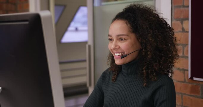 Creative businesswoman wearing headset talking in modern office