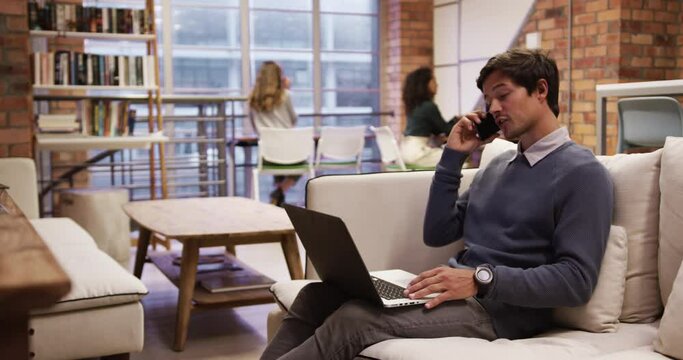 Creative businessman using laptop in modern office