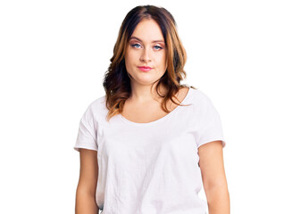 Young beautiful caucasian woman wearing casual white tshirt relaxed with serious expression on face. simple and natural looking at the camera.