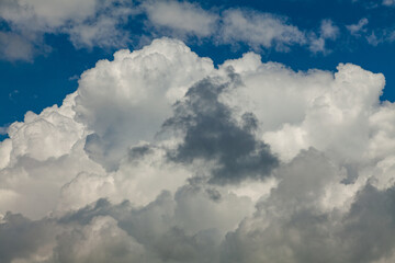 Naklejka na ściany i meble White cumulus clouds on a blue sky background