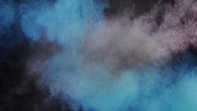 Smoke moving and colorful powder explosion against black background