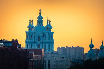 Saint Petersburg. Russia. Smolny Cathedral. Orthodox church on background of sunset. Smolny Cathedral on background of orange sky. Domes of Russian church. Sights of Russia. Evening St. Petersburg