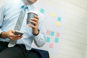 Professional Business man hand hold drink fresh coffee in paper cup glasses morning refreshing coffee break before working meeting computer smartphone mobile