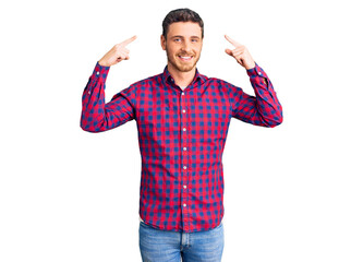 Handsome young man with bear wearing casual shirt smiling pointing to head with both hands finger, great idea or thought, good memory