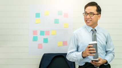 Professional Business man hand hold drink fresh coffee in paper cup glasses morning refreshing coffee break before working meeting computer smartphone mobile