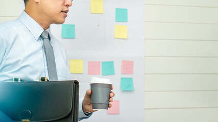 Professional Business man hand hold drink fresh coffee in paper cup glasses morning refreshing coffee break before working meeting computer smartphone mobile