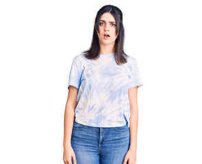 Obraz premium Young beautiful girl wearing casual t shirt in shock face, looking skeptical and sarcastic, surprised with open mouth