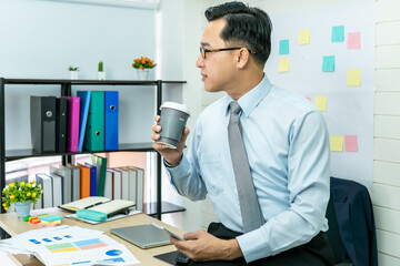 Professional Business man hand hold drink fresh coffee in paper cup glasses morning refreshing coffee break before working meeting computer smartphone mobile