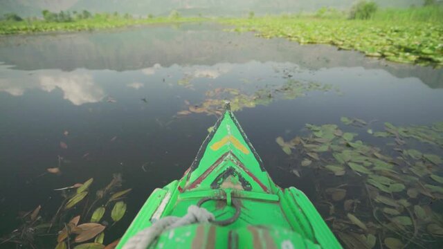 Green Shikara Boat Travelling At The Dal Lake In Kashmir, India. - medium shot