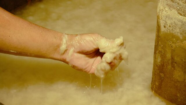 Anonymous Hand Taking Out Paper Pulp out of Tank in Paper Mill Workplace, Close Up
