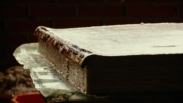 Wet Manufactured Paper Sheets Laid Down to Dry on a Pile in Traditional Paper Mill