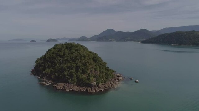 Aerial cinematic shot around an island seen from the top