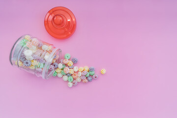 Colorful hard candies on pink background